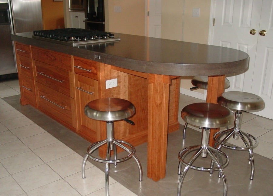 Custom kitchen island with storage and seating in cherry.